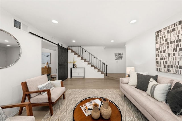 living room featuring hardwood / wood-style flooring and a barn door