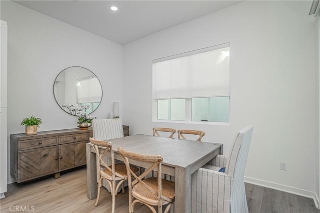 dining space with wood-type flooring