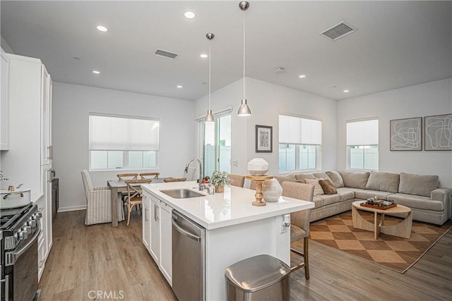 kitchen with sink, white cabinets, and appliances with stainless steel finishes