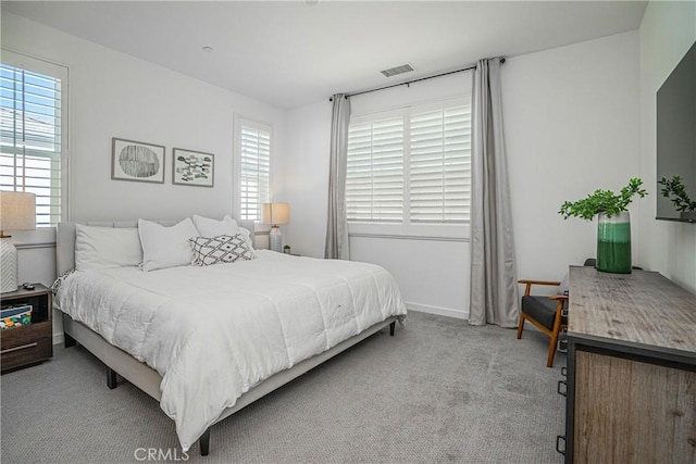 carpeted bedroom with multiple windows