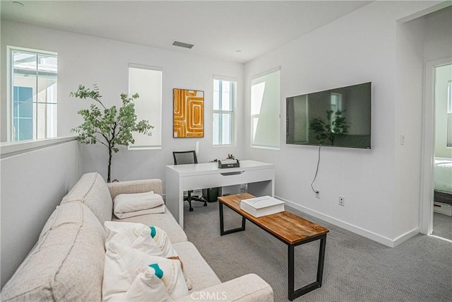 living room with a healthy amount of sunlight and carpet