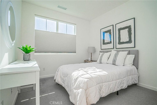 bedroom featuring dark carpet