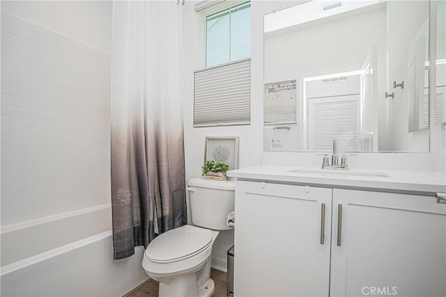 full bathroom with shower / bath combo with shower curtain, toilet, and vanity