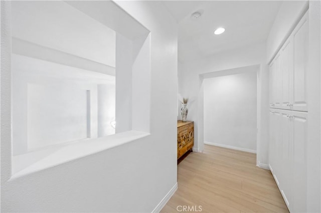 hall with light wood finished floors, recessed lighting, and baseboards