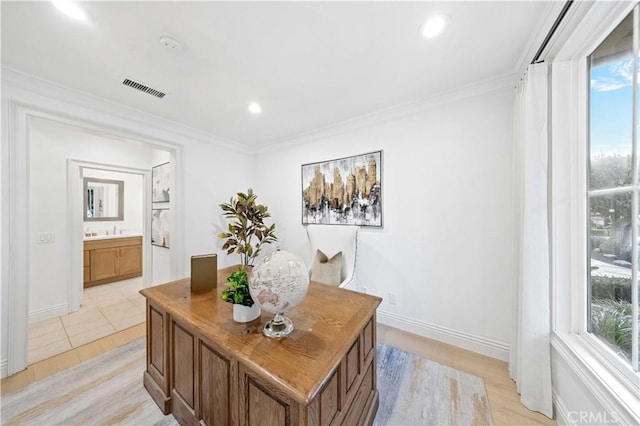 office space with a wealth of natural light, visible vents, and crown molding