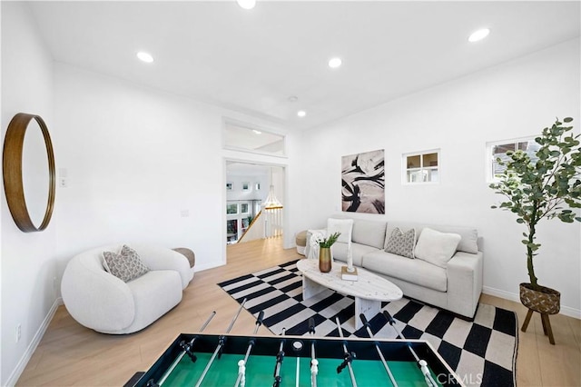 living room featuring baseboards, wood finished floors, and recessed lighting