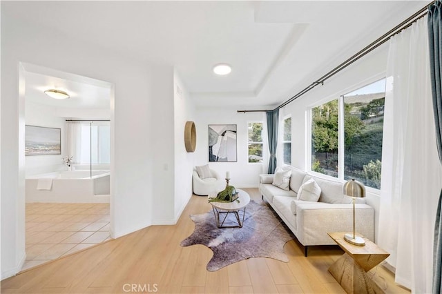 living room featuring light wood finished floors and baseboards