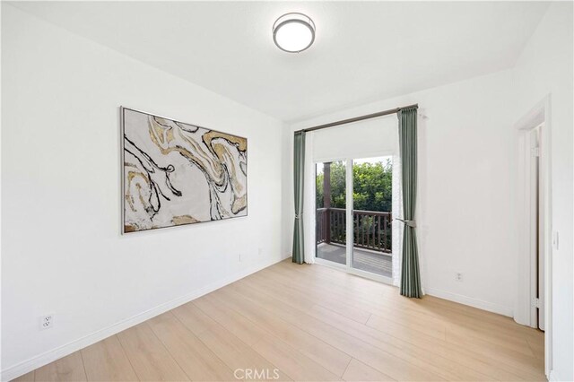 empty room with light hardwood / wood-style flooring