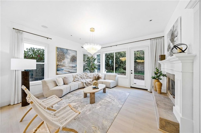 sunroom with a glass covered fireplace and an inviting chandelier