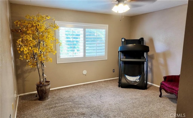 sitting room with carpet floors and ceiling fan