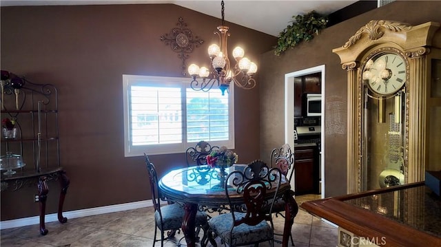 tiled dining area featuring lofted ceiling and a chandelier