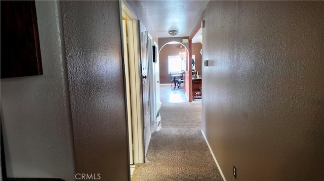 hallway featuring light colored carpet