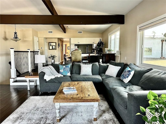 living room featuring dark wood-type flooring and lofted ceiling with beams