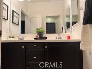 bathroom featuring double vanity