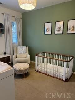 bedroom featuring a nursery area