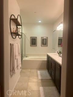 bathroom with vanity and a bath