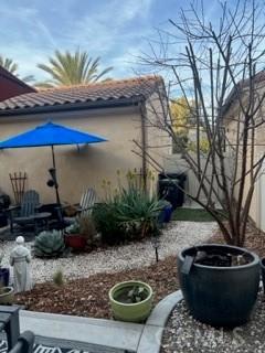 view of side of property with a tiled roof and stucco siding