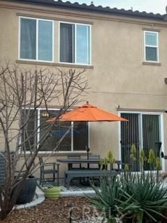 back of house with stucco siding