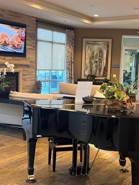 living area featuring a fireplace, wood finished floors, and recessed lighting