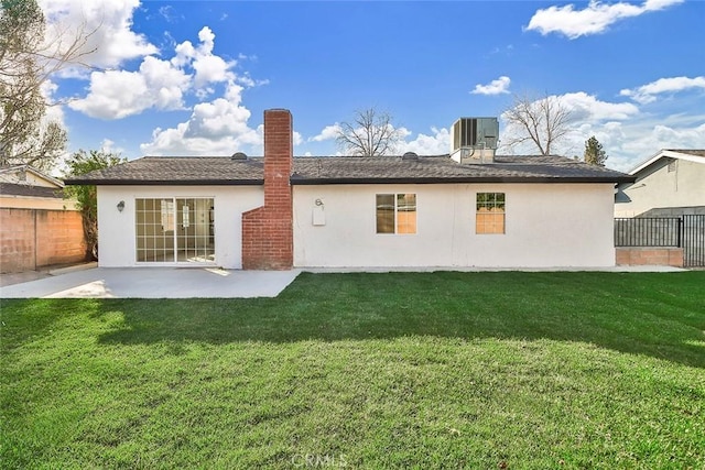 back of property featuring a lawn, a patio, and cooling unit