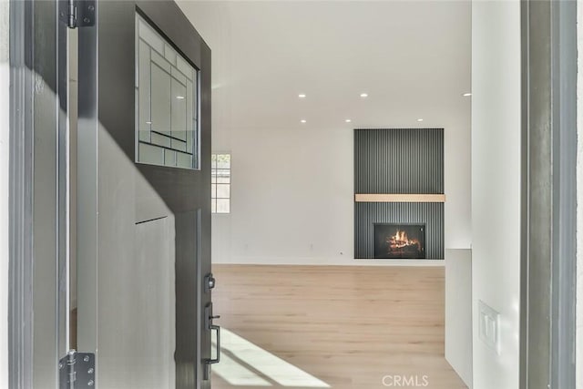 living room with light wood-type flooring and a fireplace