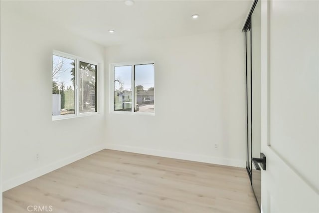 empty room with light hardwood / wood-style floors