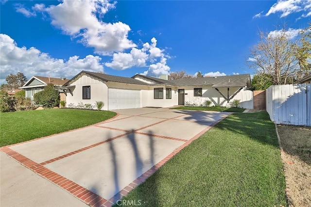 view of front of home with a garage and a front lawn