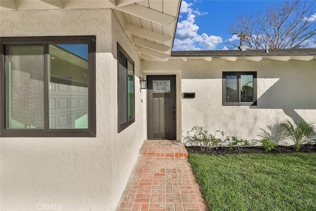 doorway to property with a yard