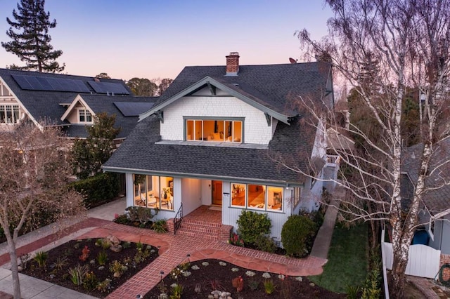 view of back house at dusk