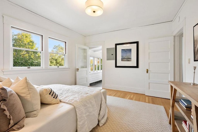 bedroom with hardwood / wood-style floors and electric panel