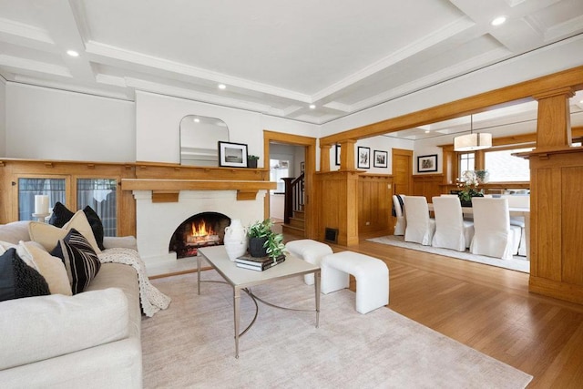 living room with coffered ceiling, light hardwood / wood-style floors, and beamed ceiling