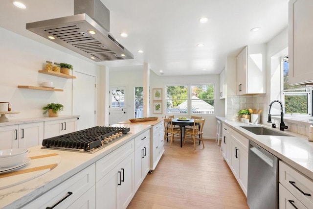 kitchen featuring white cabinetry, appliances with stainless steel finishes, sink, and island range hood