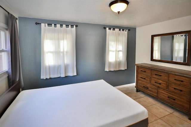 bedroom featuring light tile patterned floors