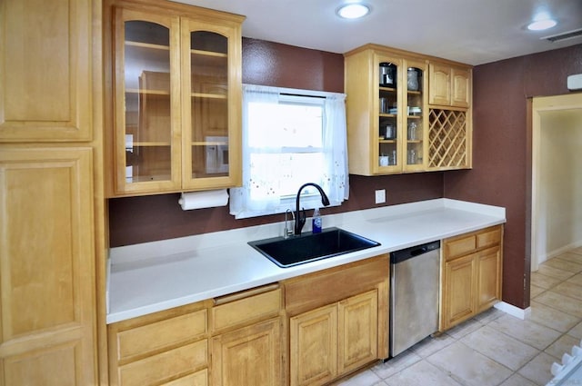 kitchen featuring light tile patterned floors, sink, and stainless steel dishwasher