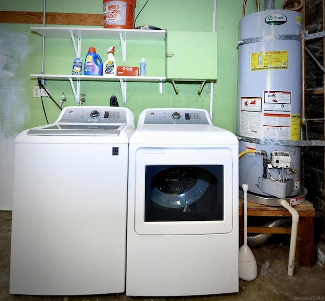 clothes washing area with washer and dryer and strapped water heater