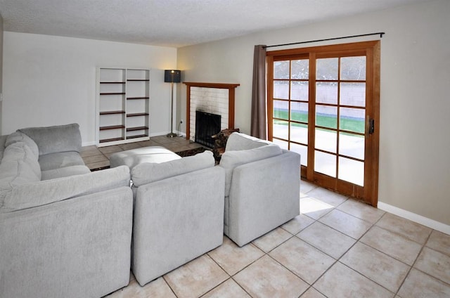 living room with a textured ceiling, light tile patterned floors, and a brick fireplace