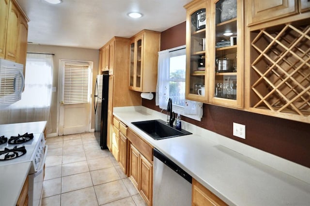 kitchen with sink, white appliances, and light tile patterned floors