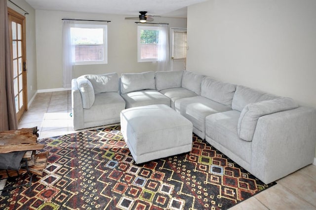 living room featuring ceiling fan and tile patterned floors