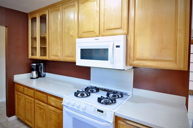 kitchen featuring white appliances and light tile patterned floors