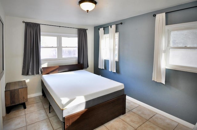 tiled bedroom featuring multiple windows