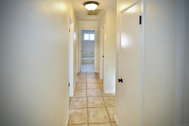 hallway featuring light tile patterned flooring