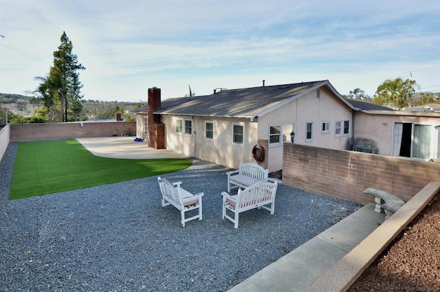 rear view of house featuring a patio area and a lawn