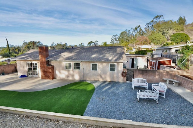 back of property featuring a patio and a yard