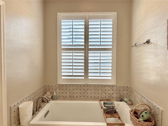 bathroom with a bath and a wealth of natural light