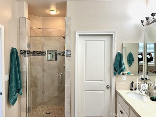 bathroom with an enclosed shower and vanity