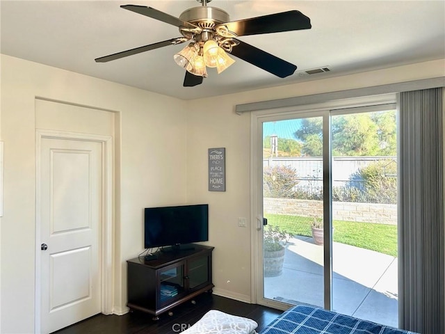 bedroom with access to exterior, ceiling fan, and dark hardwood / wood-style flooring