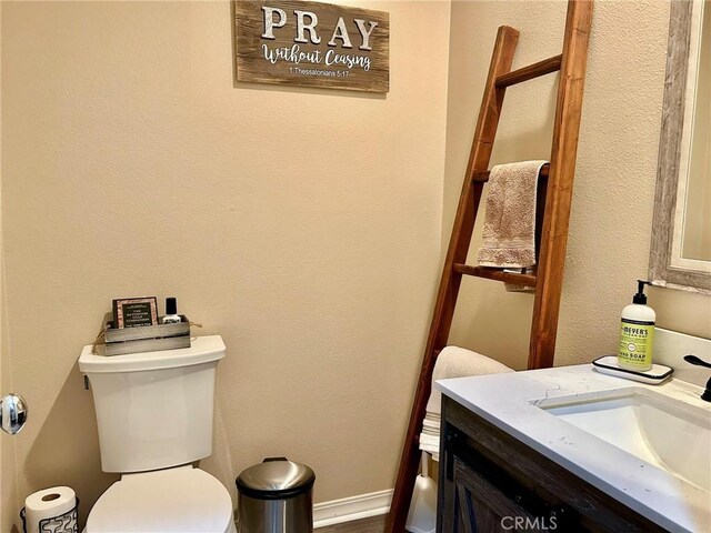 bathroom with toilet and vanity