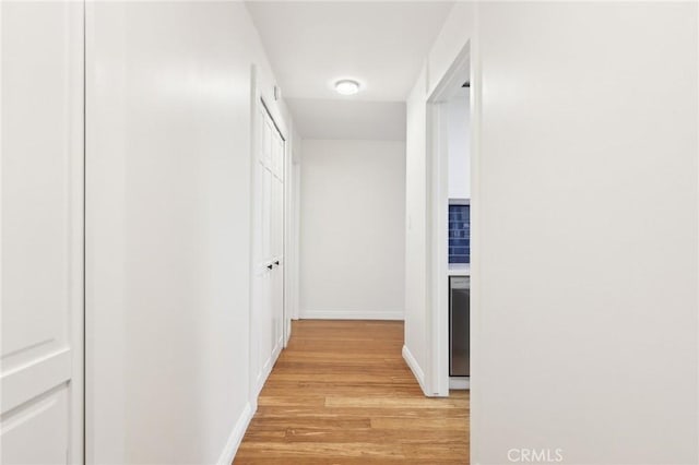 corridor with light wood-type flooring