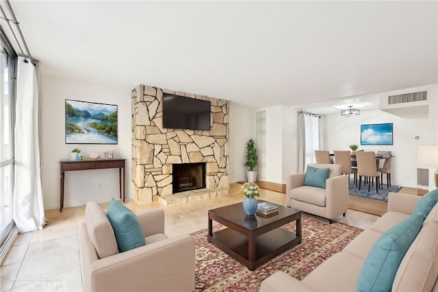 living room featuring a fireplace and light tile patterned flooring