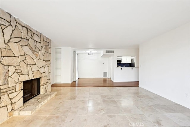 unfurnished living room with a fireplace